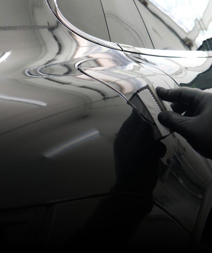 Ceramic coating being applied to the door of a Tesla