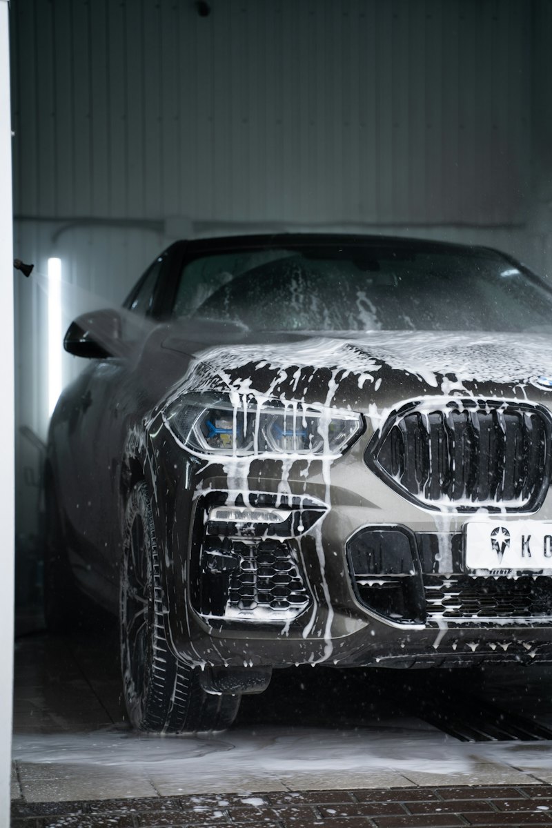 A car covered in foam during a detailing wash