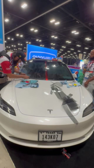 Paint protection film being installed on the front of a Tesla