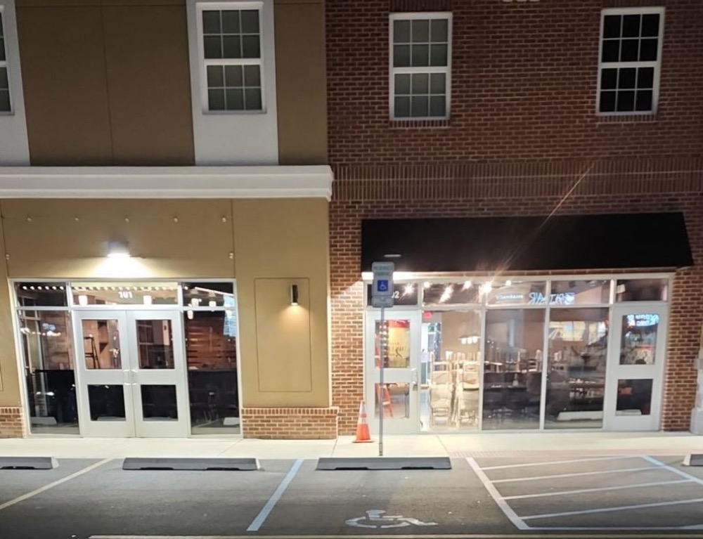 The tinted storefront lit up at night